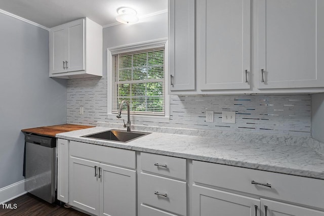 kitchen with dark hardwood / wood-style floors, white cabinetry, sink, backsplash, and stainless steel dishwasher