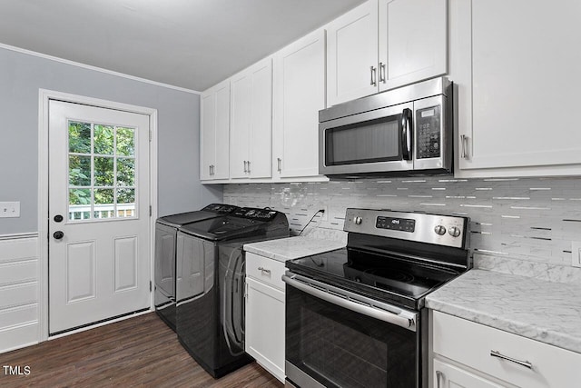 kitchen with white cabinetry, stainless steel appliances, dark hardwood / wood-style floors, washer and dryer, and decorative backsplash