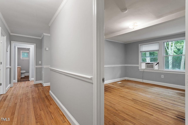 hallway with cooling unit, light hardwood / wood-style flooring, and ornamental molding