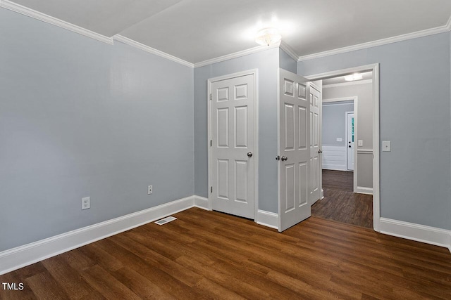 unfurnished bedroom featuring dark wood-type flooring and ornamental molding