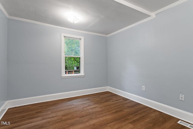 empty room featuring ornamental molding and dark hardwood / wood-style floors