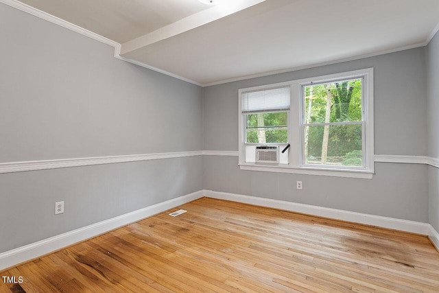 spare room featuring crown molding, light hardwood / wood-style floors, and cooling unit