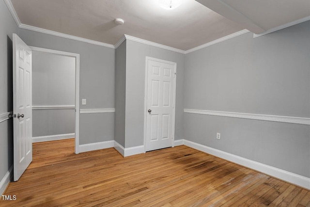 unfurnished bedroom featuring ornamental molding and light hardwood / wood-style flooring