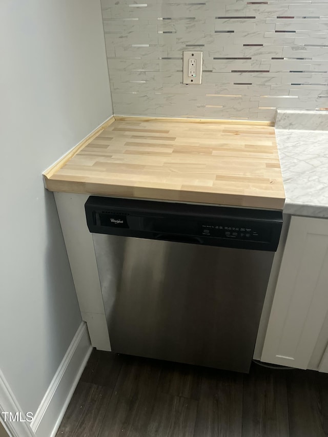 room details featuring butcher block countertops, backsplash, wood-type flooring, and stainless steel dishwasher