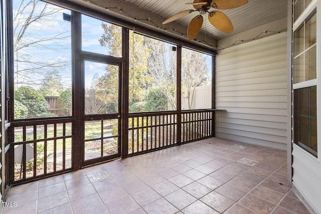 unfurnished sunroom with a ceiling fan and wooden ceiling