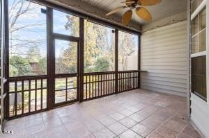 unfurnished sunroom featuring ceiling fan