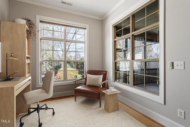 living area featuring baseboards, visible vents, wood finished floors, and ornamental molding