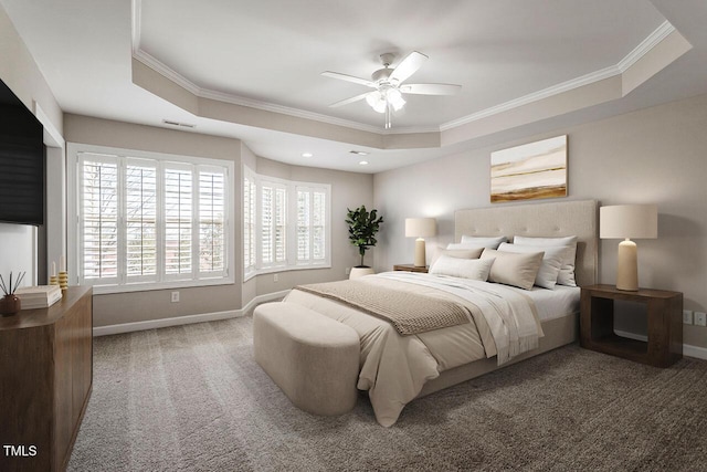 bedroom with ornamental molding, a raised ceiling, carpet floors, and baseboards