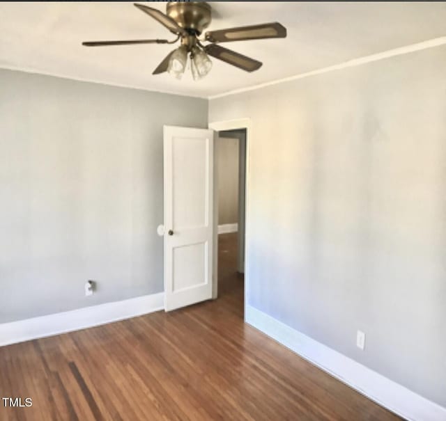 spare room featuring dark hardwood / wood-style floors and ceiling fan