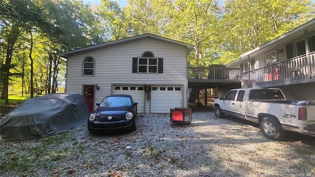 view of side of property featuring a garage and a wooden deck