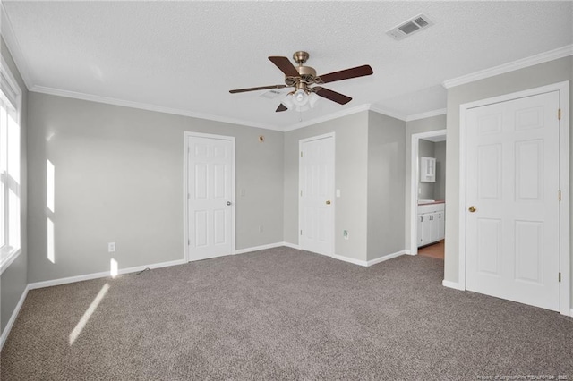 unfurnished bedroom with carpet floors, ceiling fan, and crown molding