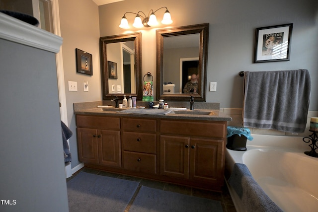 bathroom with tile patterned flooring, vanity, and a washtub