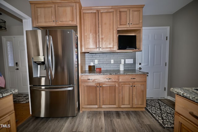 kitchen with dark hardwood / wood-style flooring, light stone countertops, stainless steel refrigerator with ice dispenser, and decorative backsplash