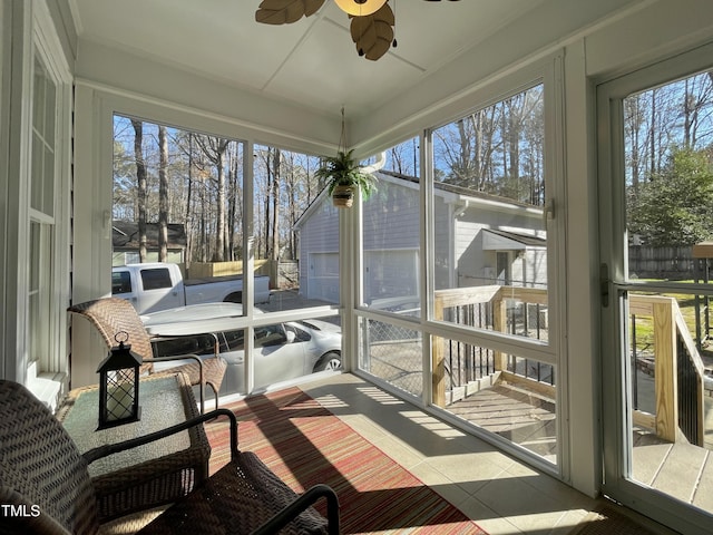 sunroom featuring ceiling fan