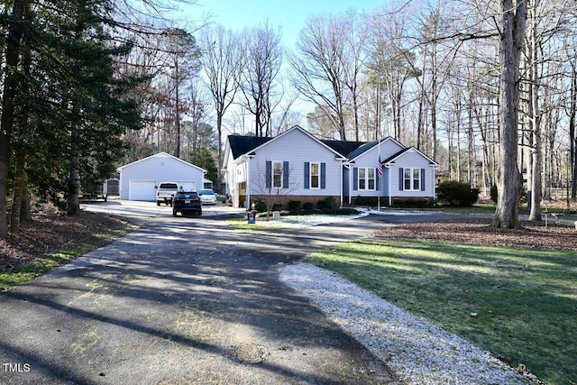 single story home with a garage and an outbuilding