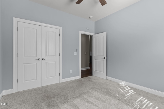 unfurnished bedroom featuring a closet, carpet flooring, and baseboards