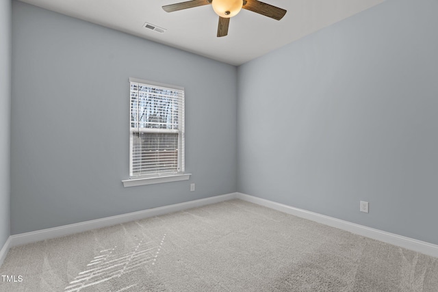 empty room featuring carpet, visible vents, ceiling fan, and baseboards