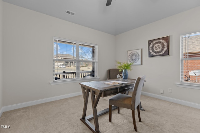 office featuring plenty of natural light, visible vents, and light colored carpet