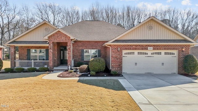 craftsman house featuring driveway, a garage, roof with shingles, covered porch, and brick siding