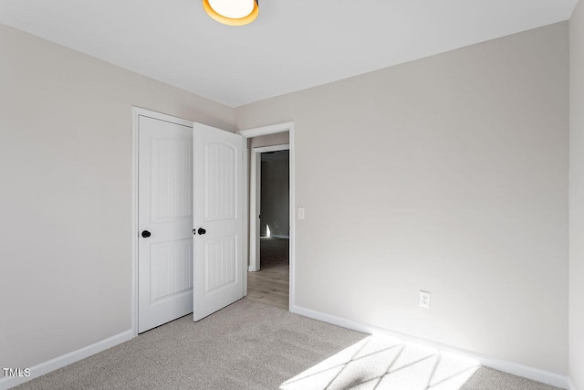 unfurnished bedroom with light carpet