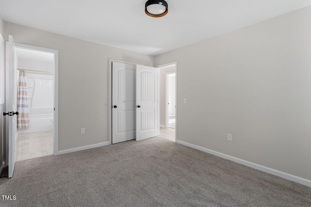 unfurnished bedroom featuring a closet and light carpet