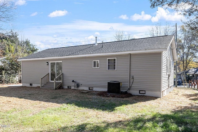 back of house with a yard and central AC unit