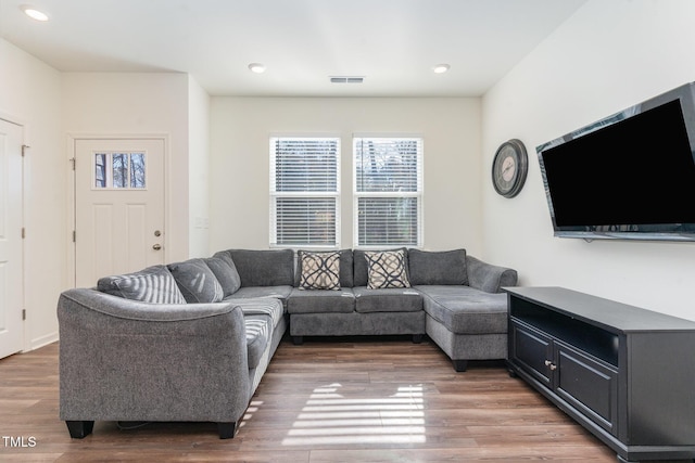 living room with visible vents, dark wood finished floors, and recessed lighting