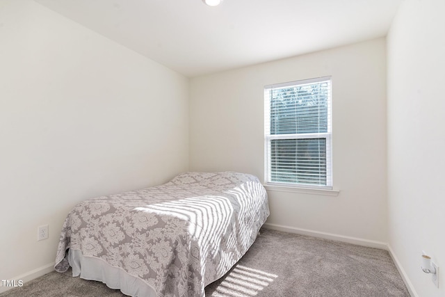 carpeted bedroom with baseboards