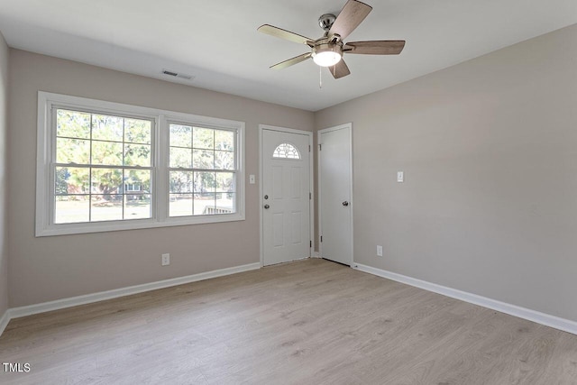 foyer entrance featuring ceiling fan and light wood-type flooring