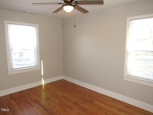 empty room with ceiling fan and hardwood / wood-style floors