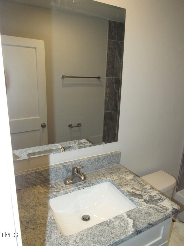 bathroom with vanity and toilet