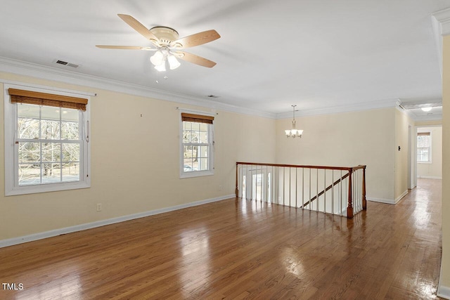 unfurnished room with a healthy amount of sunlight and ornamental molding