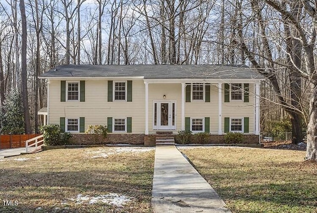 split foyer home with a front lawn