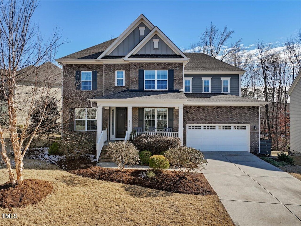 craftsman house featuring covered porch and a garage