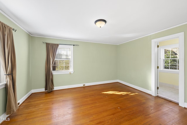 spare room with hardwood / wood-style floors and ornamental molding