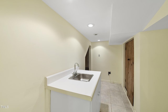 clothes washing area with sink and light tile patterned floors