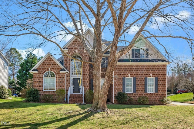 traditional-style home with a front lawn and brick siding