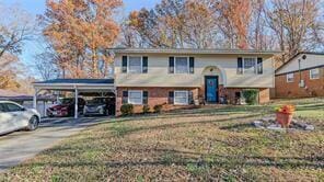 split foyer home with a front lawn