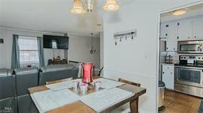 dining space featuring washer / clothes dryer and dark tile patterned flooring