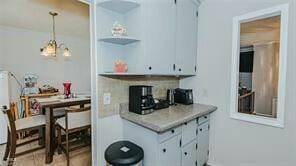 kitchen featuring pendant lighting and backsplash