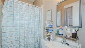 bathroom featuring sink and curtained shower