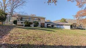 rear view of house featuring a lawn