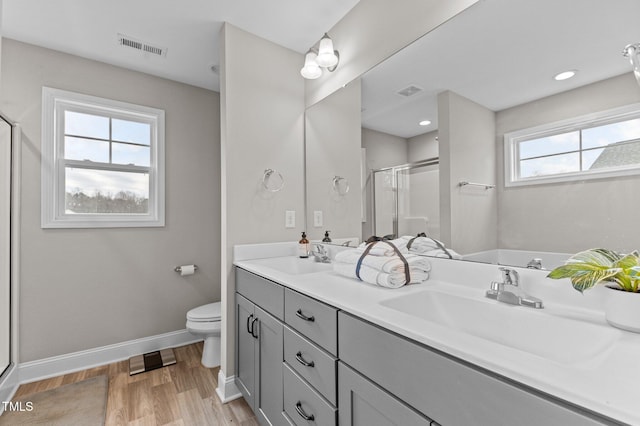 bathroom featuring vanity, toilet, an enclosed shower, and hardwood / wood-style floors