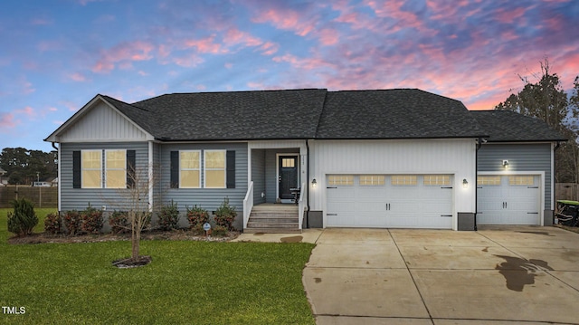 ranch-style house featuring a garage and a lawn