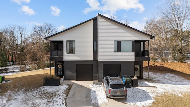 exterior space with a garage and a sunroom