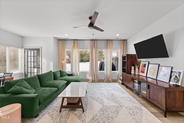 living room with ceiling fan and light hardwood / wood-style floors