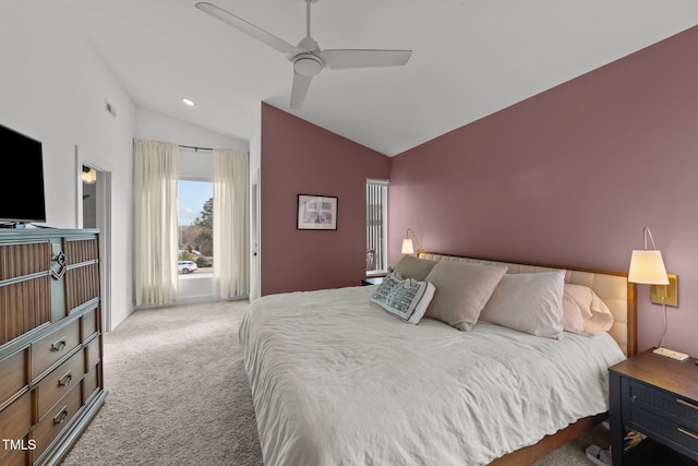 carpeted bedroom with ceiling fan and vaulted ceiling