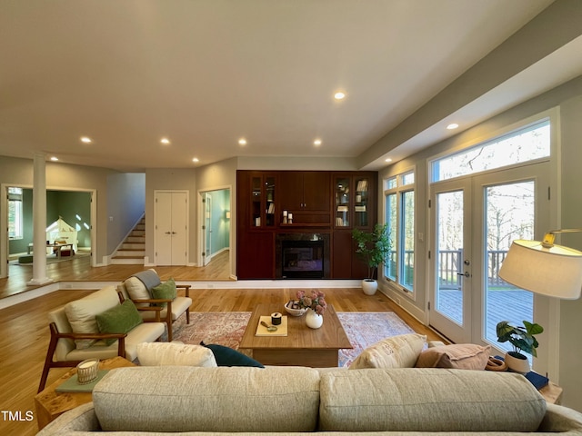 living room featuring light wood-type flooring and a wealth of natural light