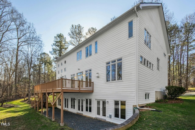 back of property with a lawn and a wooden deck