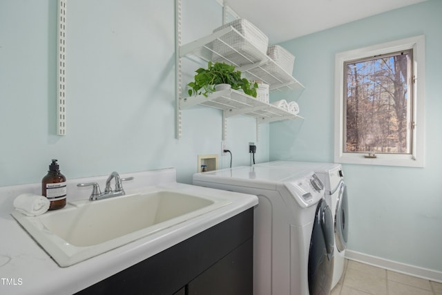 laundry room with separate washer and dryer, sink, and light tile patterned floors